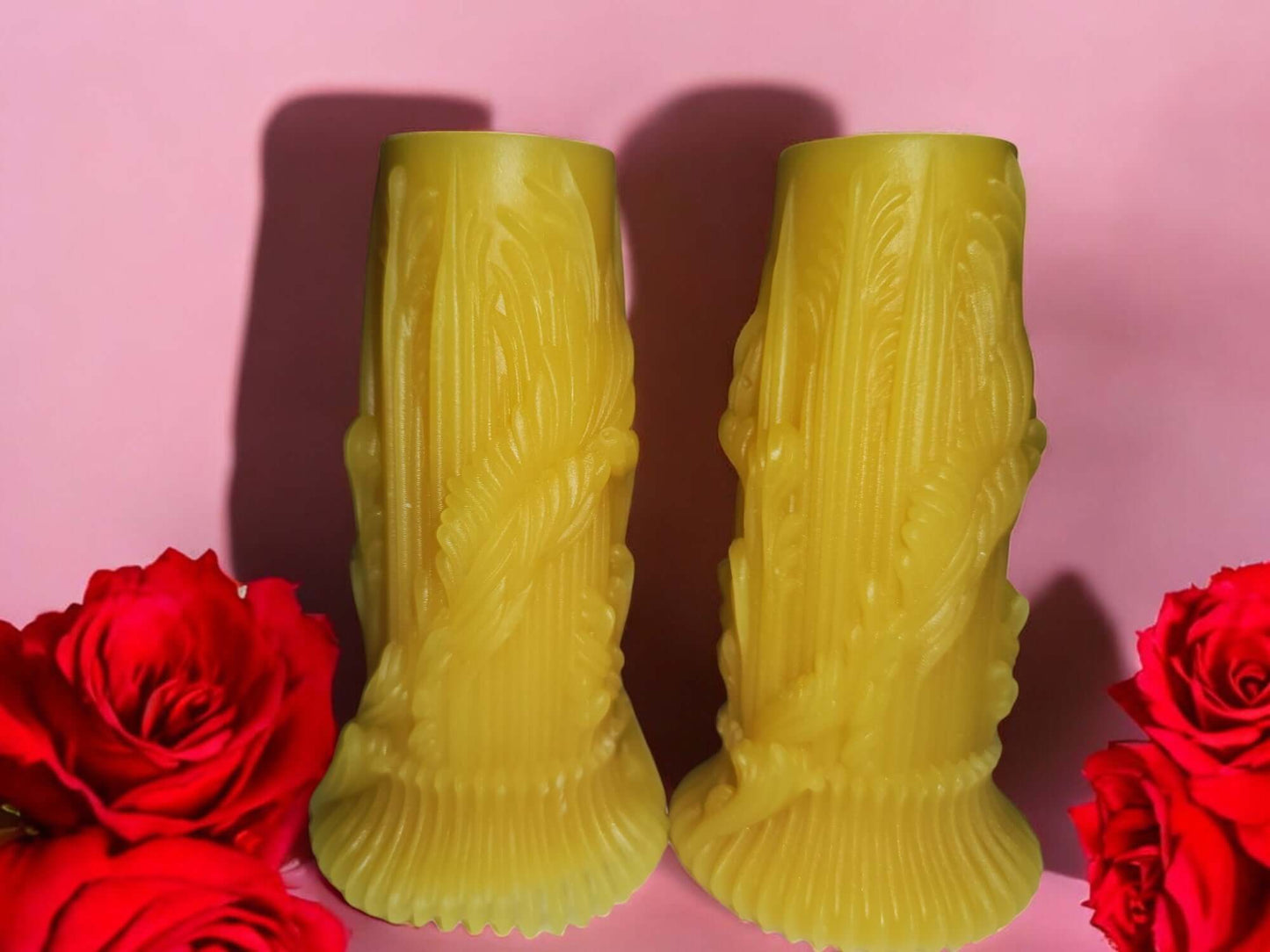 Sensual drip massage candles in a decorative design, surrounded by red roses, perfect for intimate moments.
