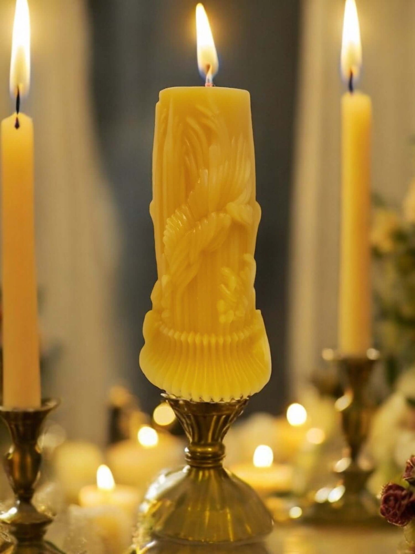 Luxury candle sticks with a beautifully carved yellow candle, creating a romantic and intimate ambiance.