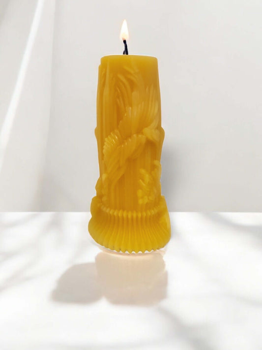 Yellow sculpted candle with a flame, ideal for sensual massage and intimate moments.