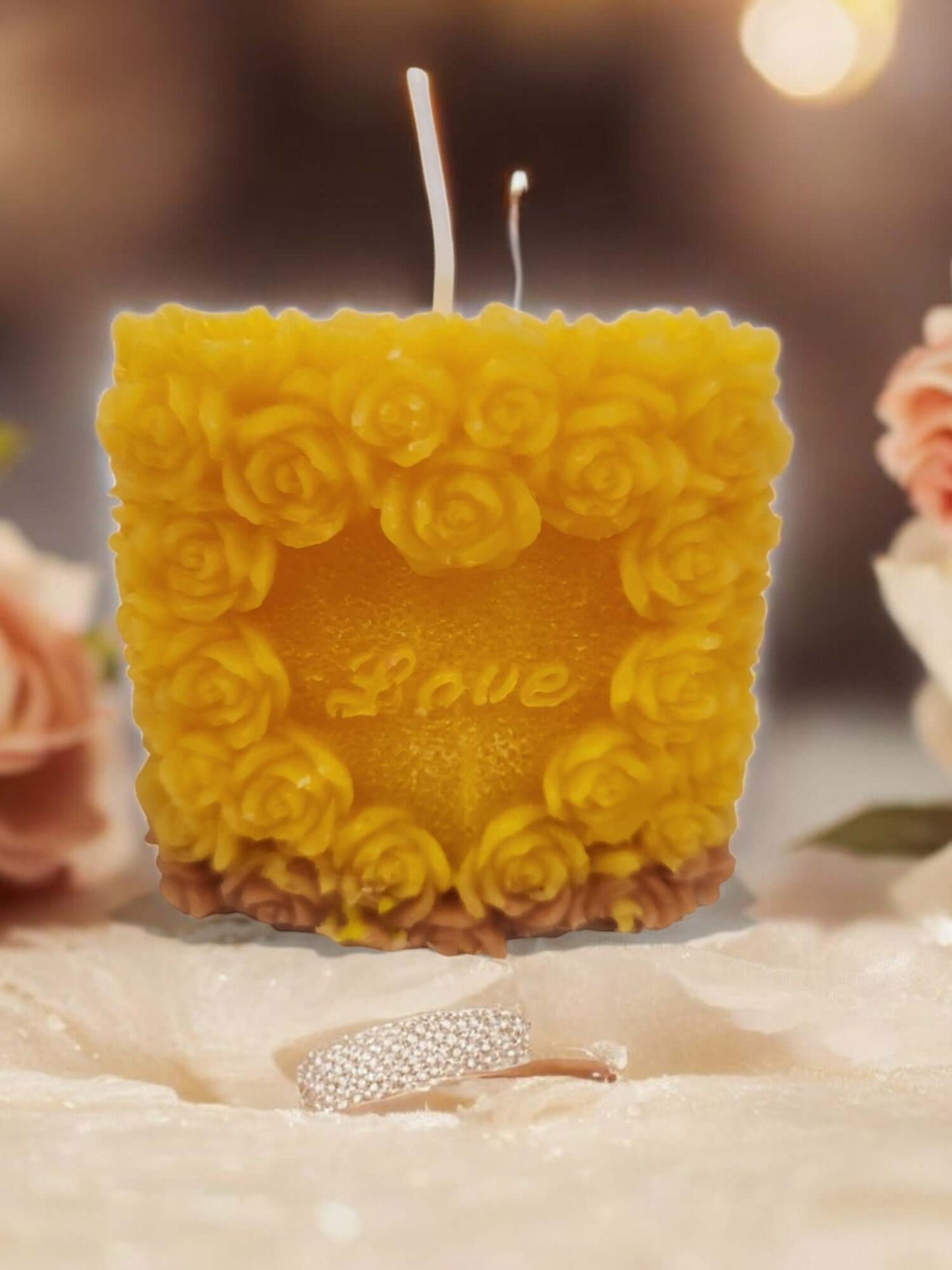 Love Rose massage candle surrounded by soft decor for sensual intimacy and relaxation.
