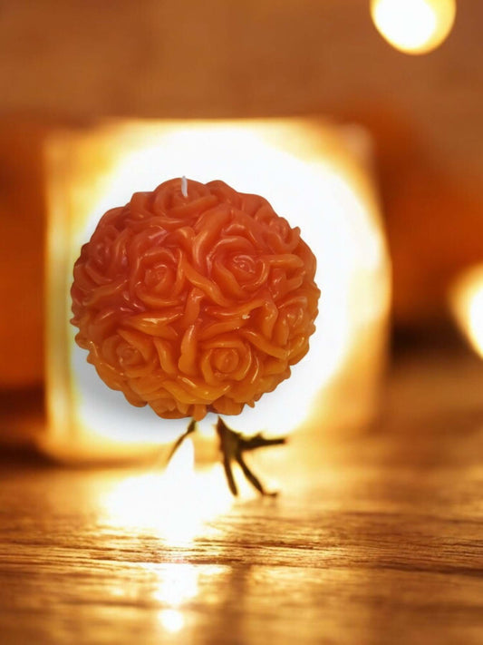 Rose Ball massage candle, designed for sensual experiences and intimacy, glowing warmly against a soft background.