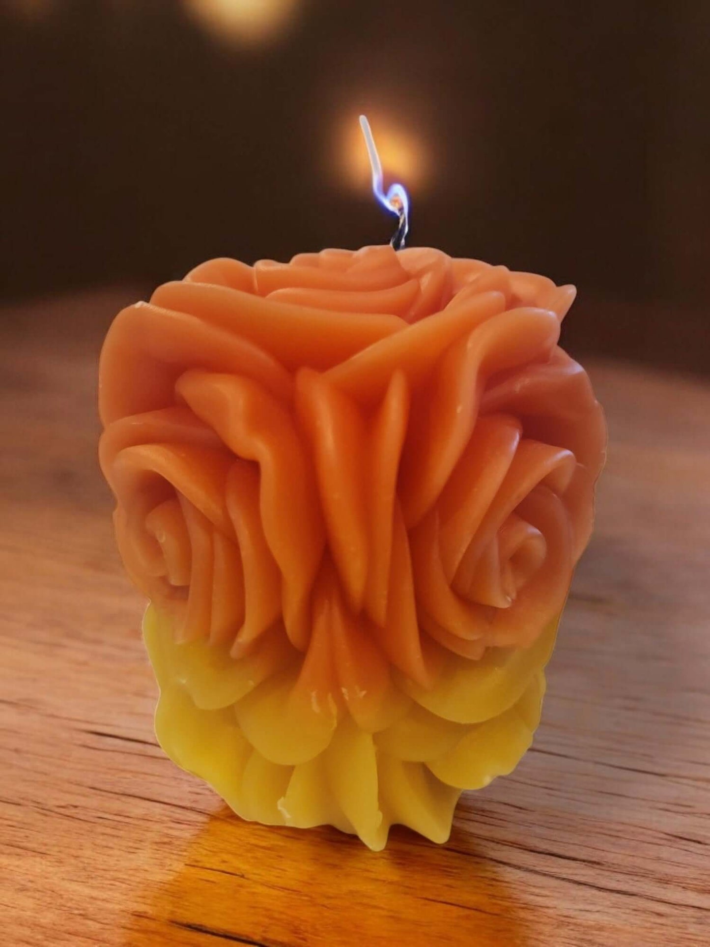 Sensual rose-shaped candle in shades of orange and yellow, perfect for intimate massage and erotic play.