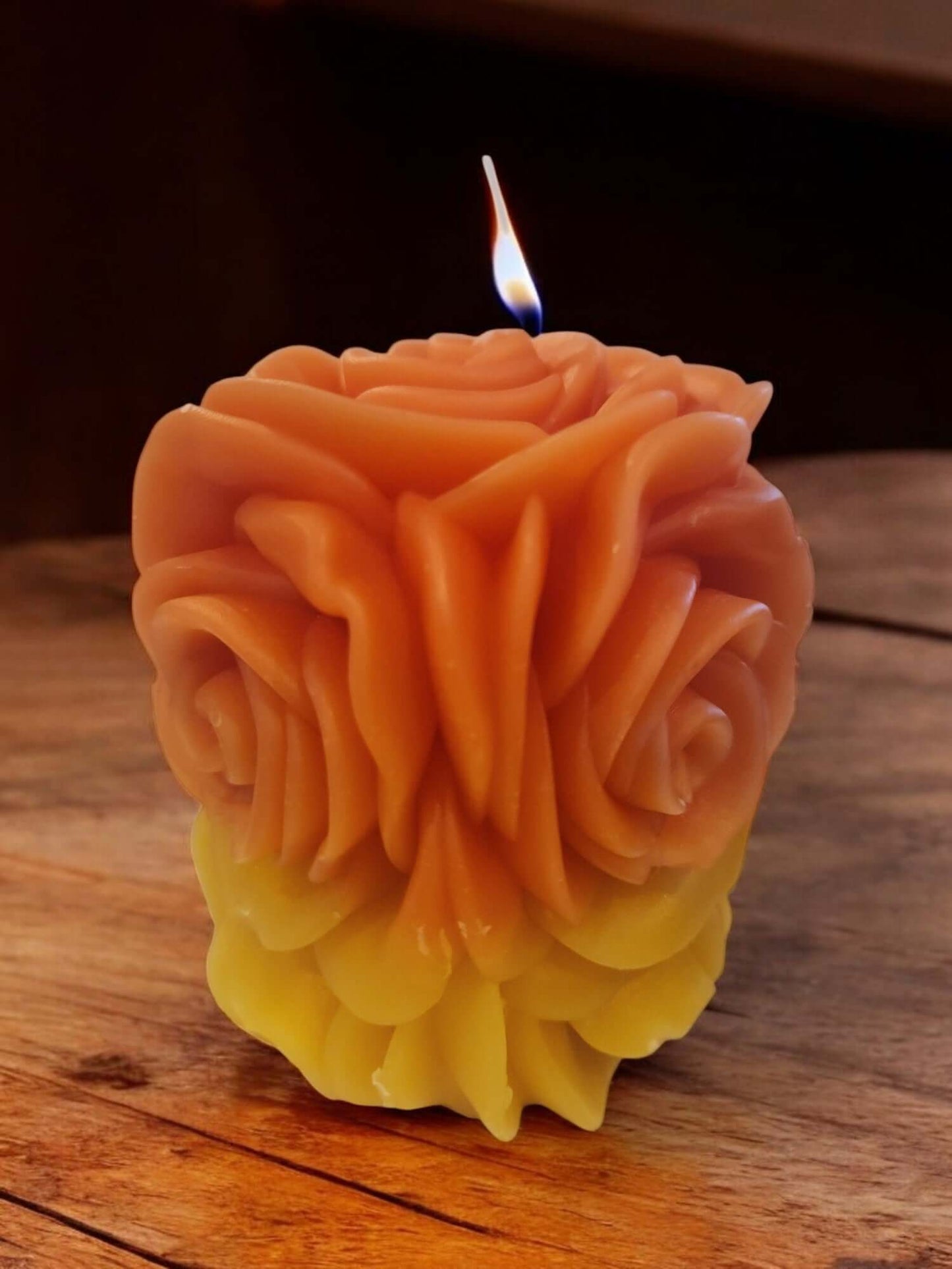 Colorful rose-shaped massage candle with a warm flame, ideal for intimacy and sensual experiences.