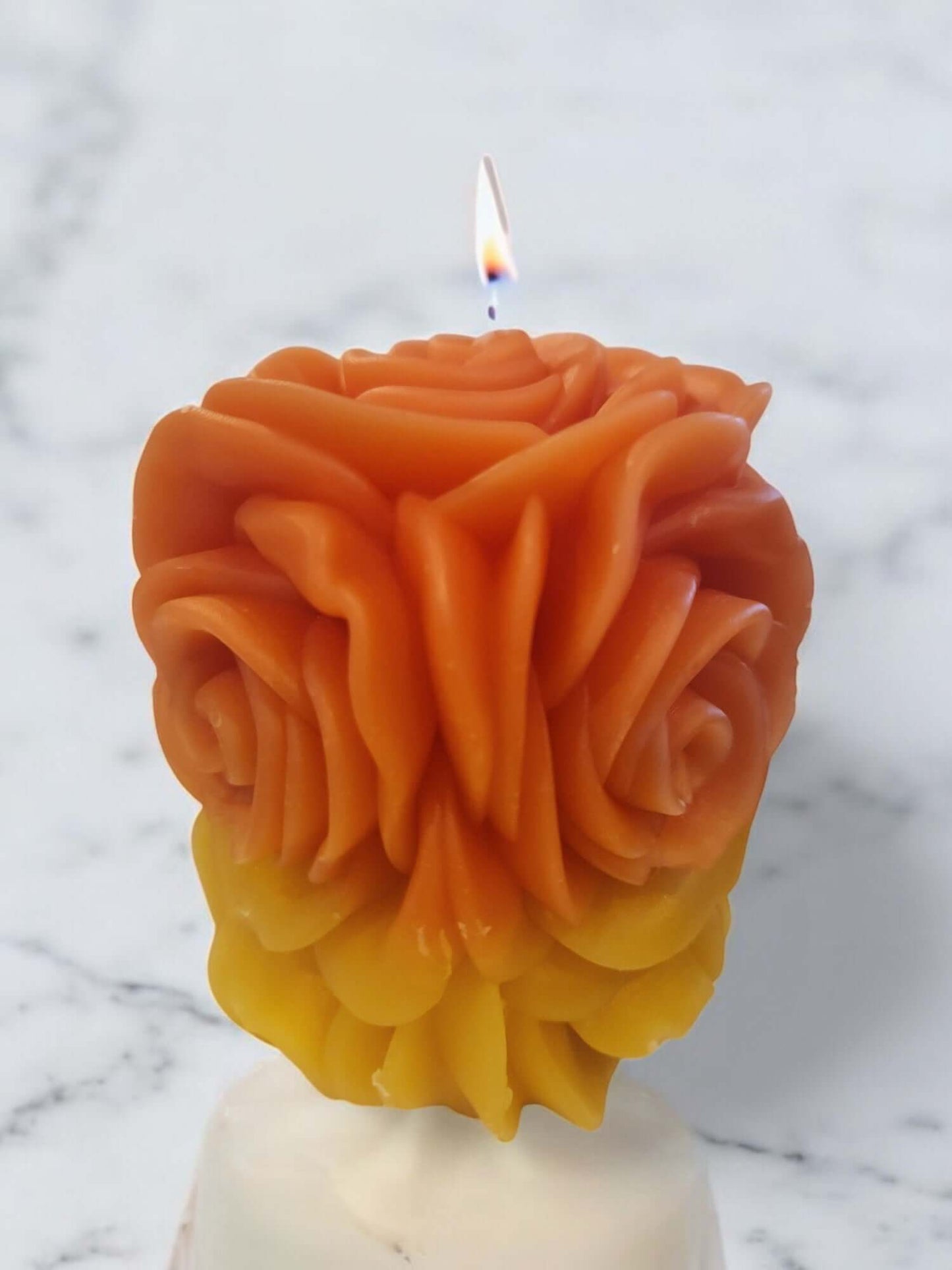 Sensual rose-shaped massage candle in gradient orange to yellow, designed for intimate foreplay and relaxation.
