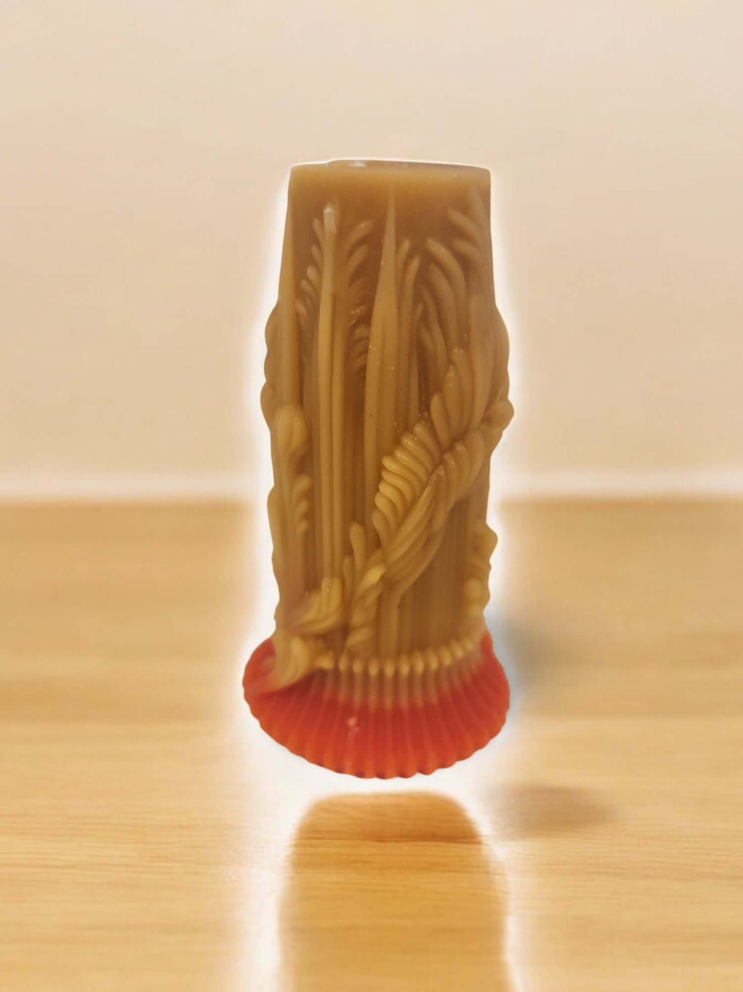Sculpted massage candle featuring intricate designs and a vibrant base, ideal for intimate experiences and relaxation.