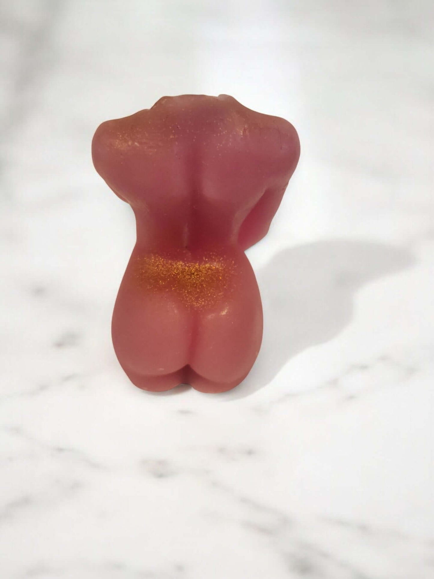 Sensual massage candle shaped like a body, perfect for intimate settings and erotic play.