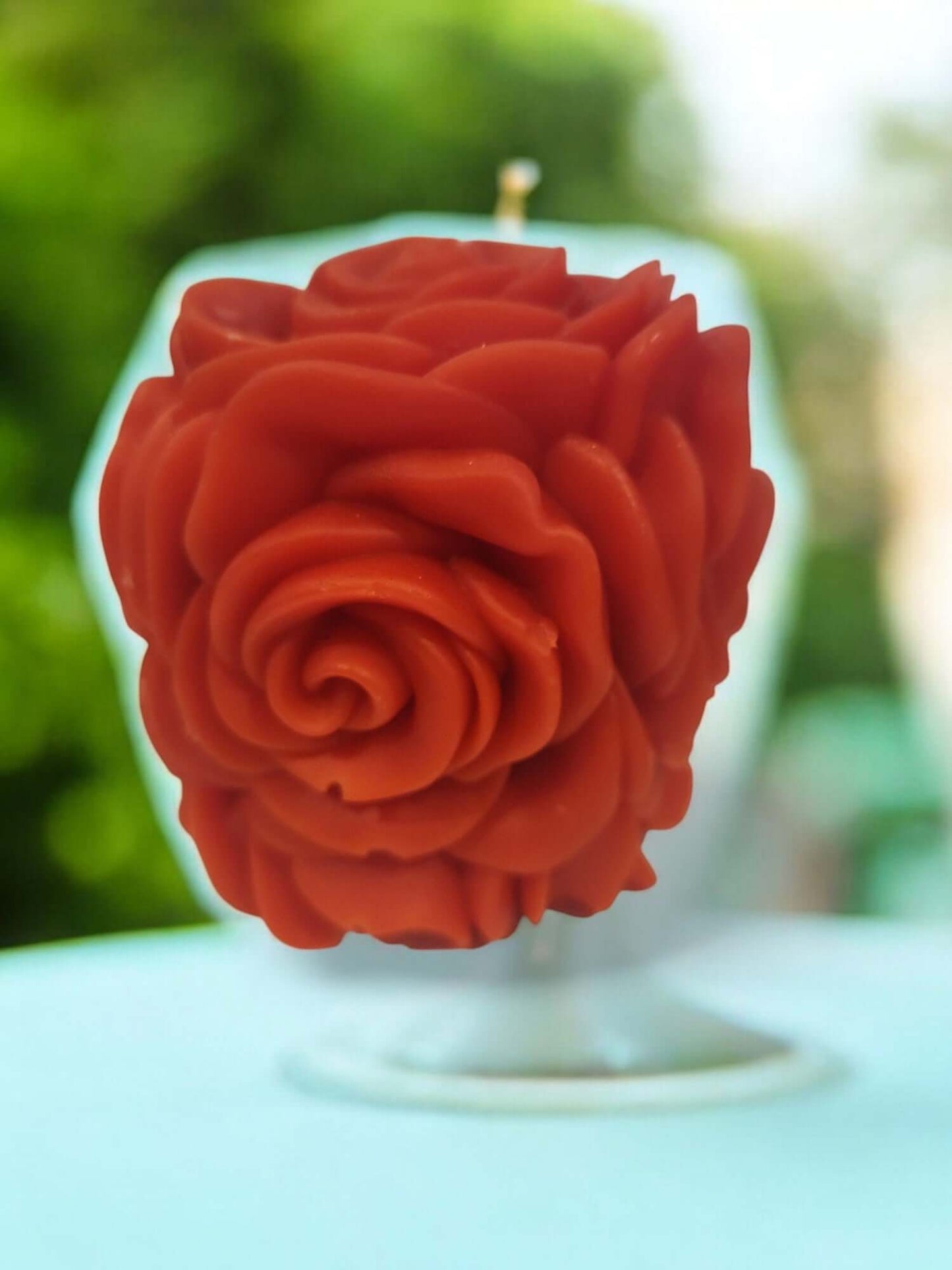 Sensual rose-shaped massage candle in vibrant red, perfect for enhancing intimacy and erotic play.
