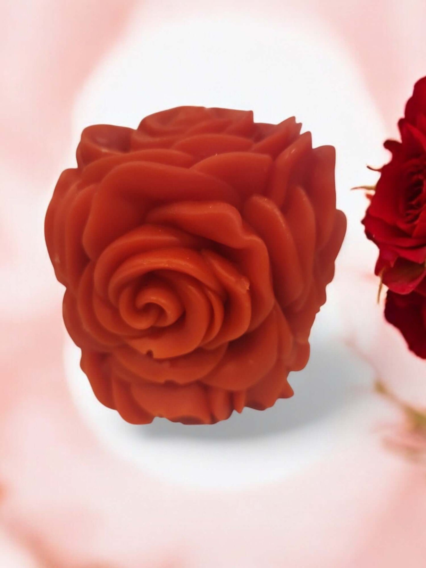 Rose-shaped sensual massage candle in warm red, perfect for enhancing intimacy and relaxation.