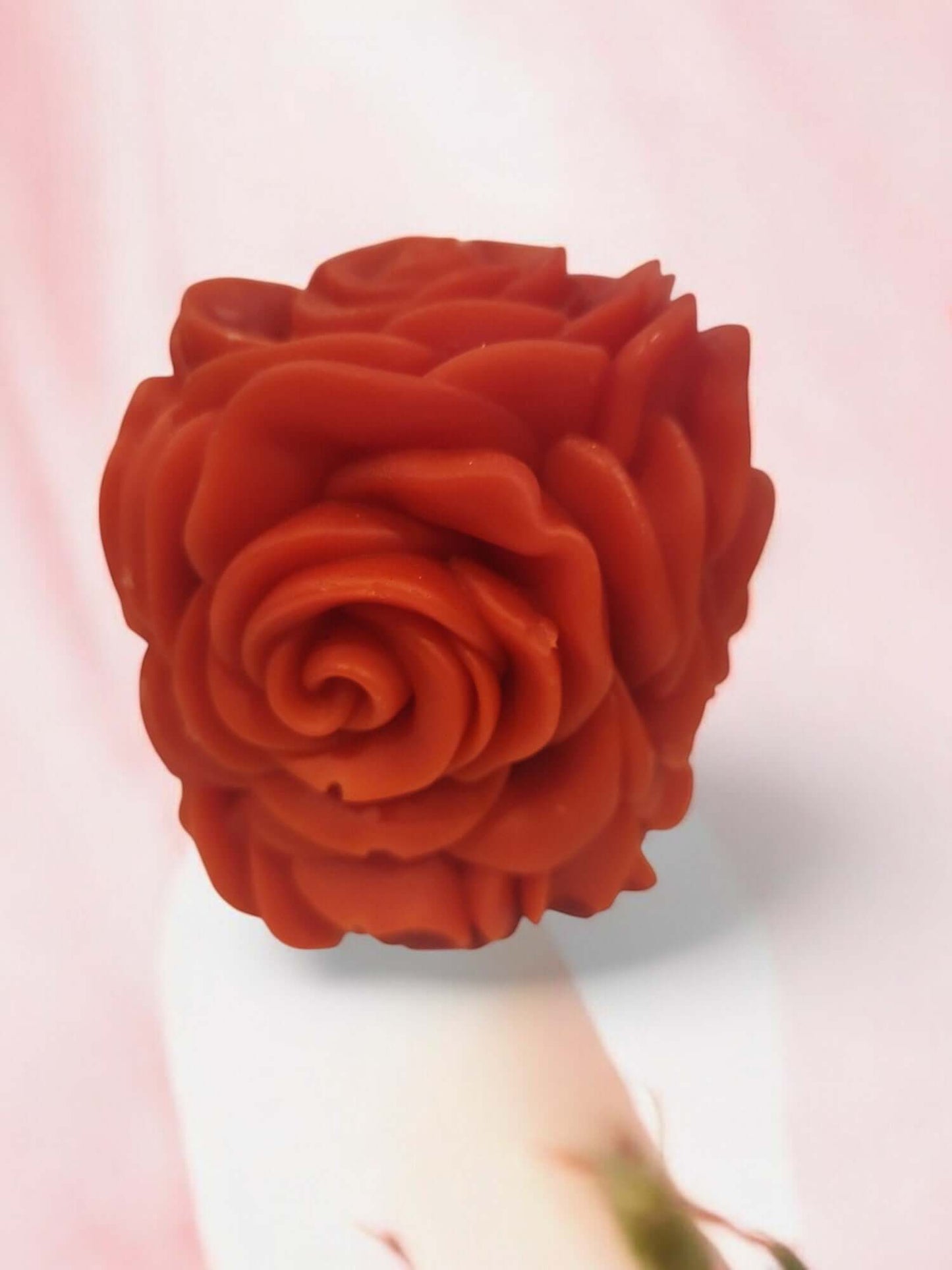 Red rose-shaped massage candle designed for sensual intimacy and erotic play.