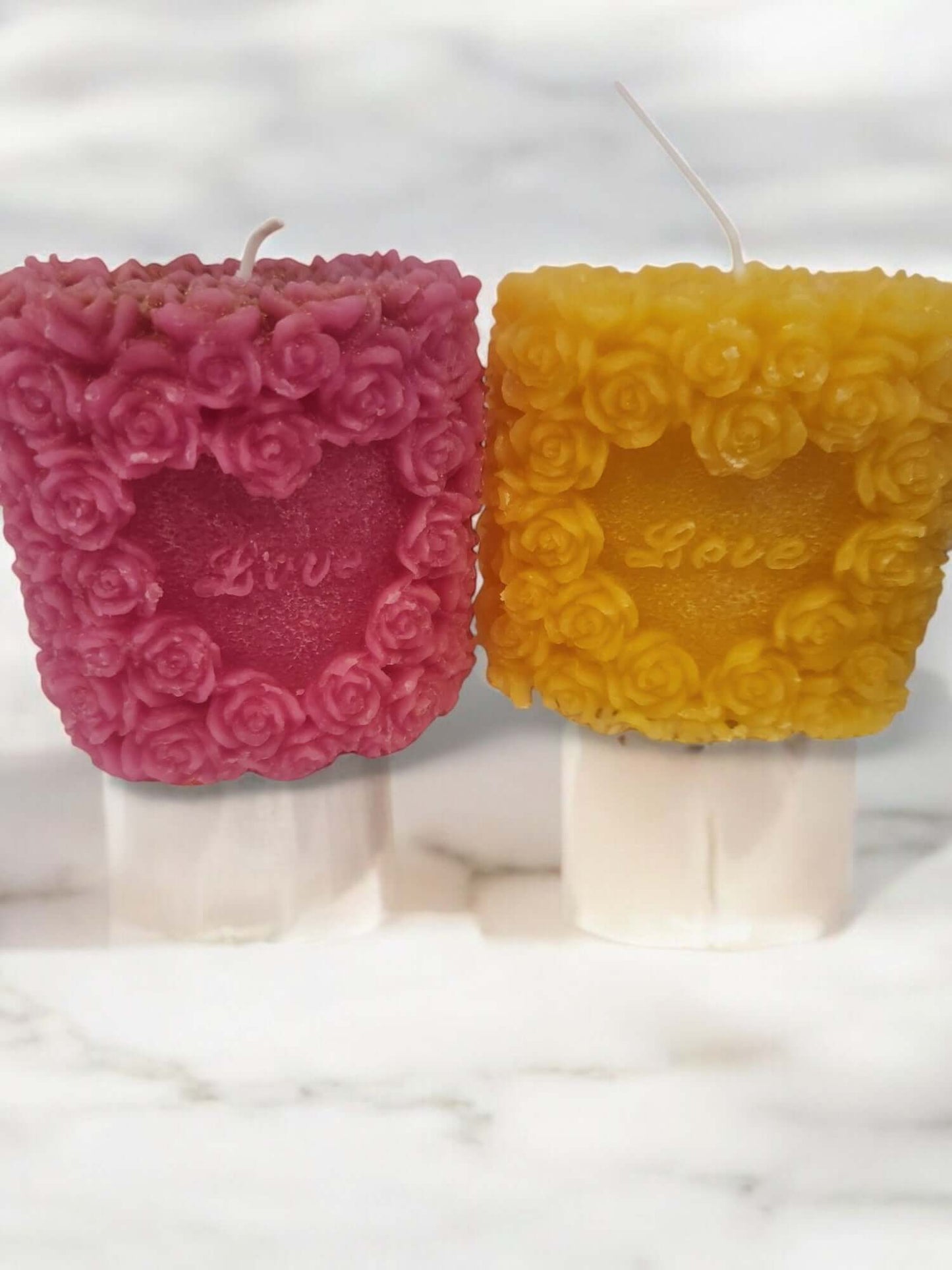 Romantic Love Rose candles in pink and yellow, perfect for sensual massage and intimate moments.