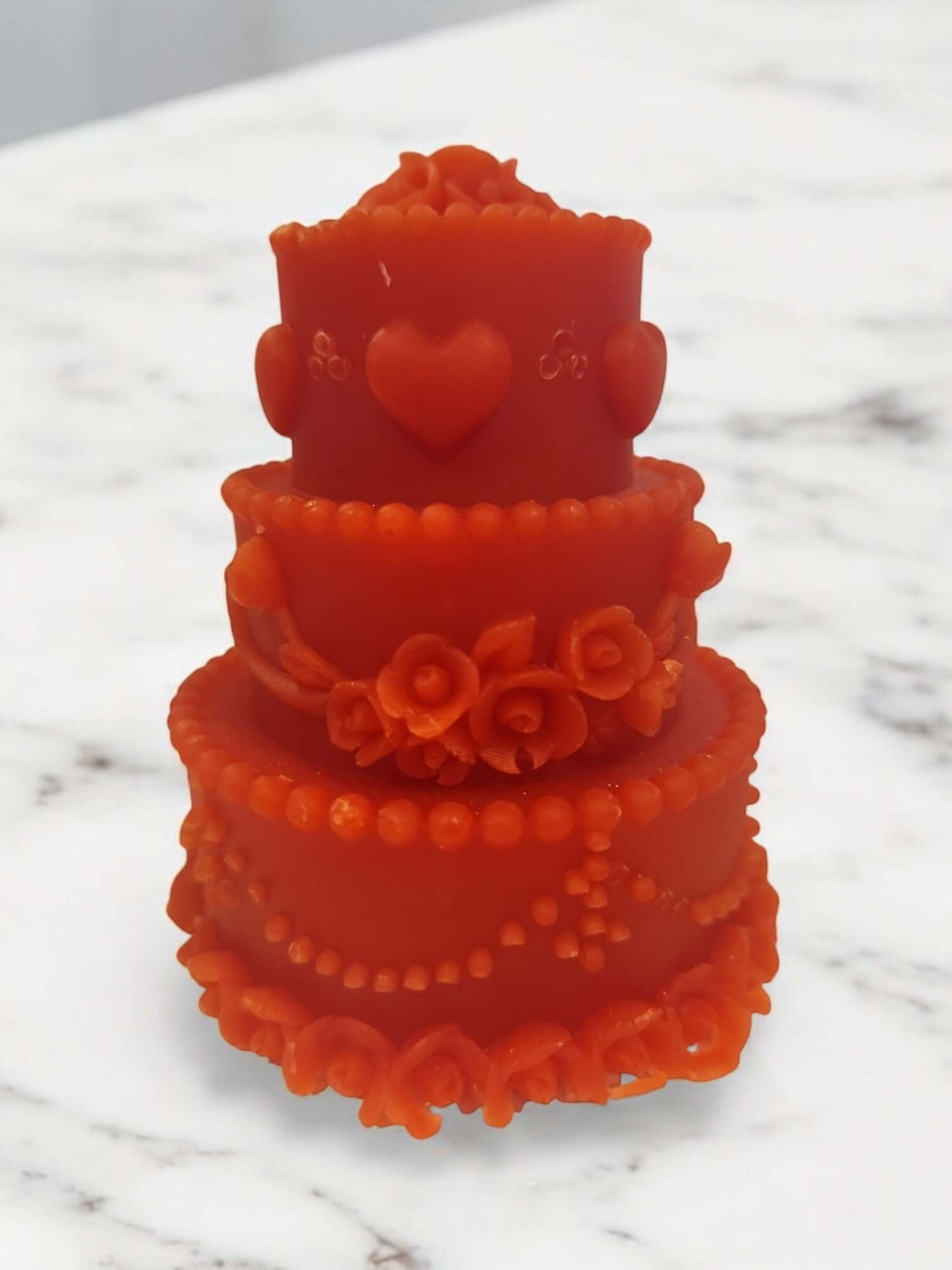 Sensual orange drip candle in a cake shape, designed for intimate massages and erotic play.