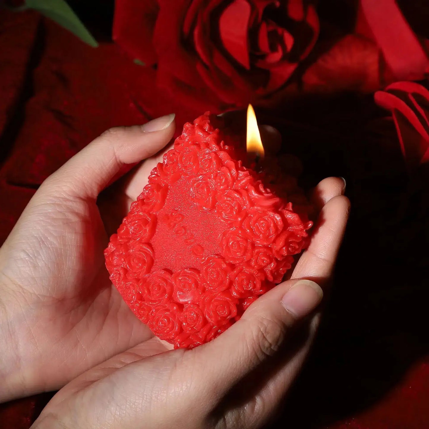 Sensual Love Rose massage candle held in hands, designed for intimate and erotic play, with elegant rose details.